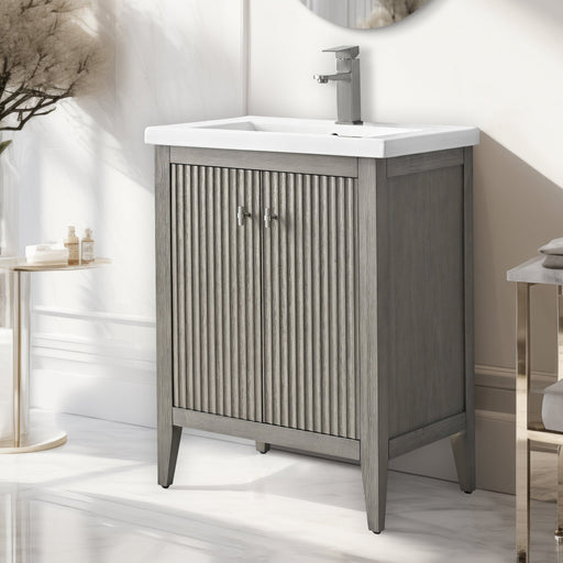 24-inch single sink bathroom vanity in gray oak wood finish with fluted doors and chrome faucet, side angle view