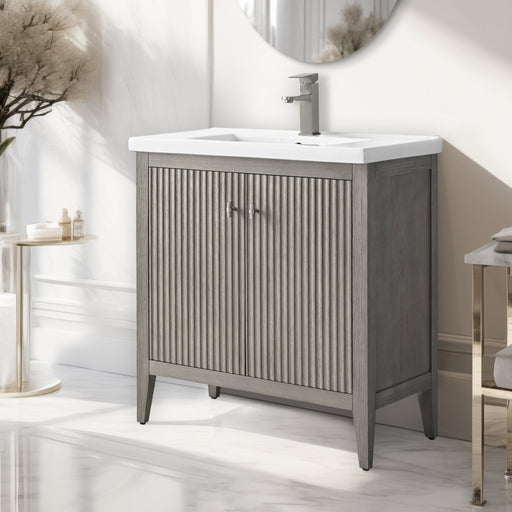 30-inch freestanding bathroom vanity in gray oak finish with reeded doors, chrome faucet and handles, white ceramic top, side angle view