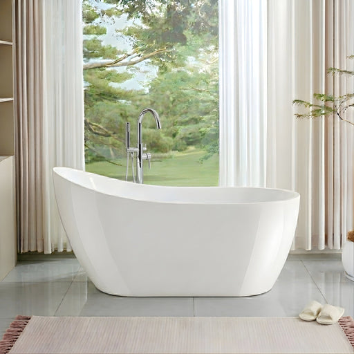 White freestanding soaking tub with chrome floor-mount faucet in bright room with floor-to-ceiling garden window