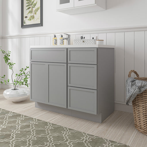 39-inch gray bathroom vanity cabinet angled view showing 1 door and 3 drawers with white sink top in bright bathroom