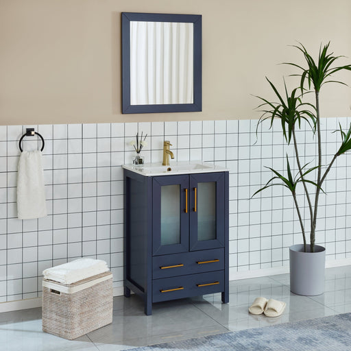 Brescia 24-inch navy blue bathroom vanity with brushed gold faucet in white tiled bathroom, slight angle view