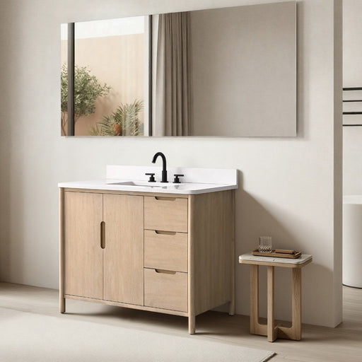 42-inch light oak single sink bathroom vanity with white top, black faucet, and large mirror in minimalist room setting
