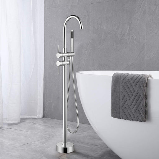 Brushed nickel freestanding tub filler with hand shower next to white freestanding soaking tub with towel