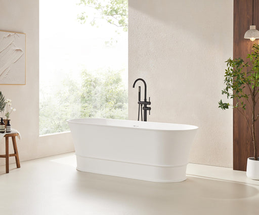 White oval freestanding soaking tub with black floor faucet, angled view in modern spa-style bathroom