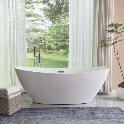 HomeBeyond 71-inch white freestanding soaking tub beside floor-mount chrome faucet with garden view window