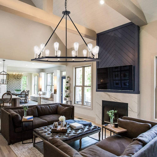 12-light farmhouse chandelier over leather sectional in open-concept living room with cathedral ceiling