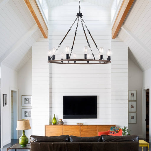 Black and walnut wagon wheel chandelier in vaulted shiplap ceiling living room with leather sofa
