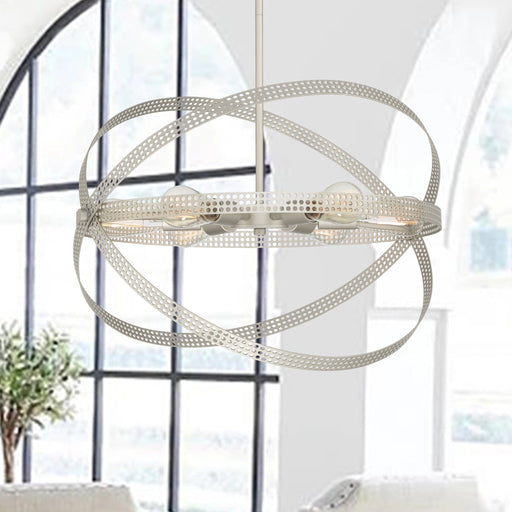 Antique silver perforated metal orbital globe pendant chandelier hanging in modern living room with large windows