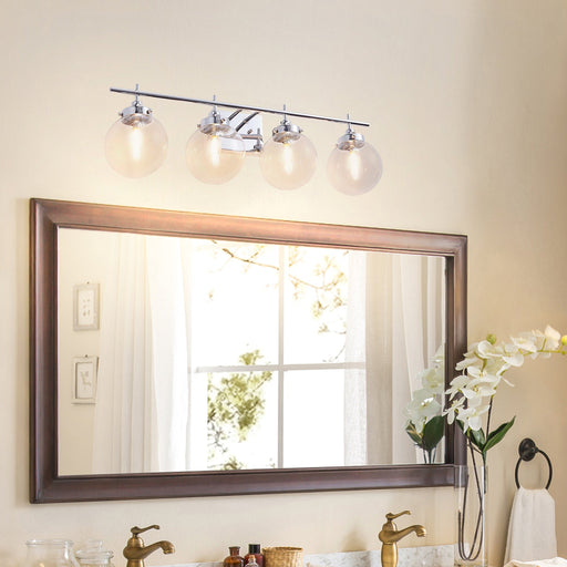 Chrome 4-light globe vanity bar above large wood-framed bathroom mirror with orchid decor